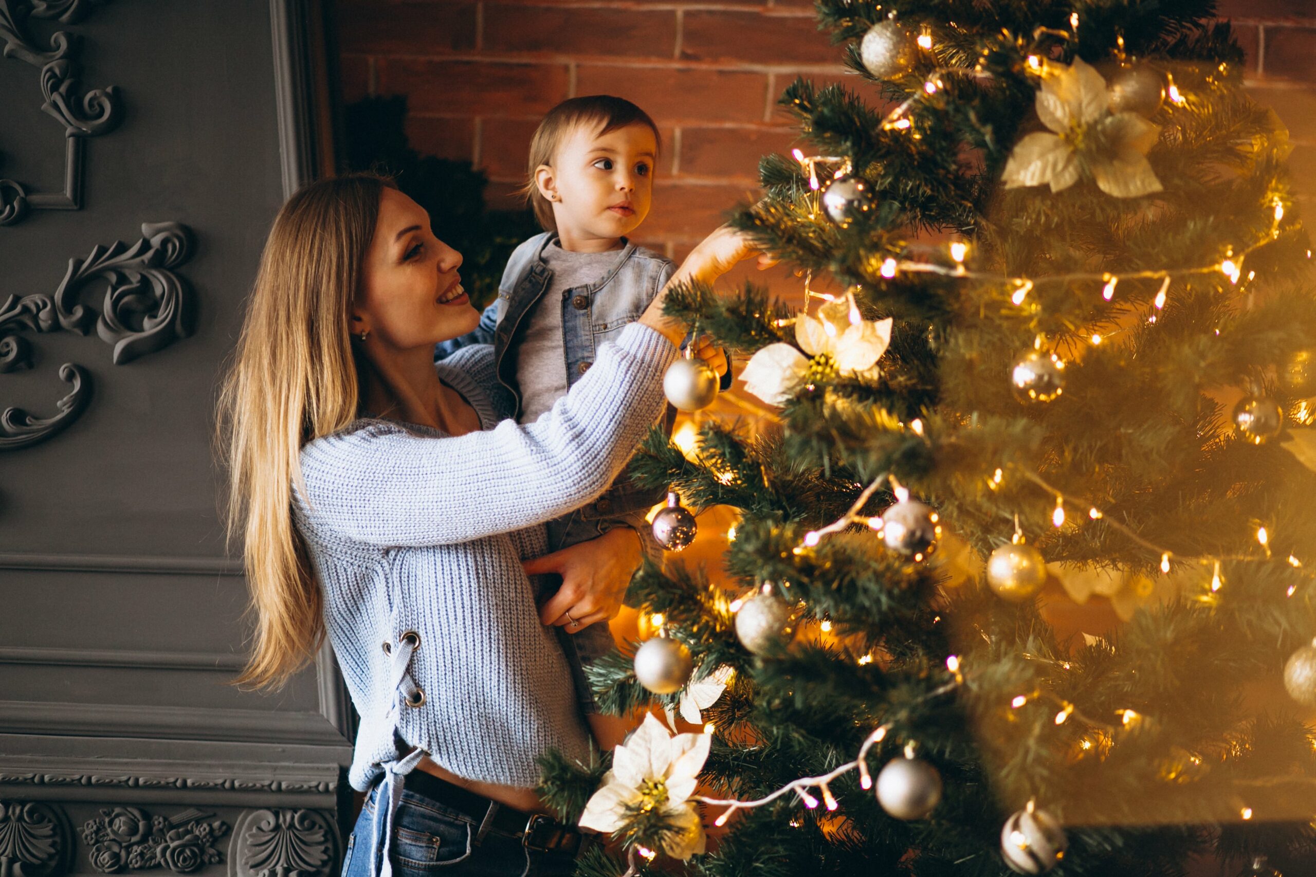 Imagem de mãe e filho montando árvore de Natal.